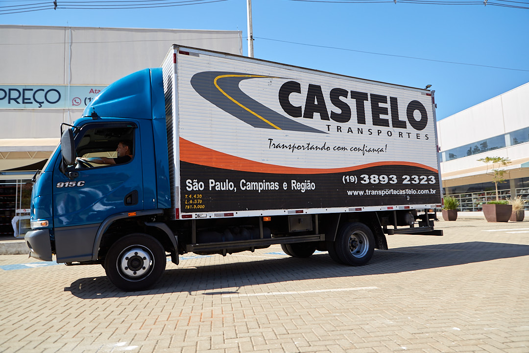 smiling truck-driver-working-gloves-opening-closing-truck-trailer-back-doors-checking-goods-transportation.jpeg